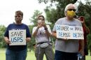 A group of protesters demonstrate in front of Postmaster General Louis DeJoy's home in Greensboro, N.C., on Sunday.
