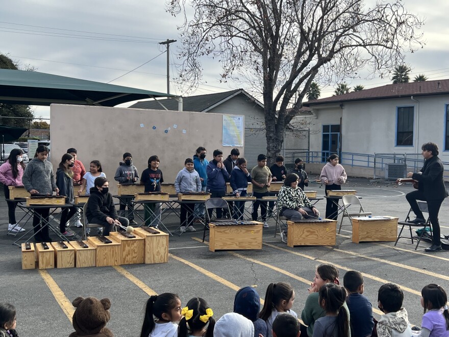 Members of the El Sistema Santa Cruz/Pajaro Valley music program at Radcliff Elementary School in Watsonville perform at a school assembly on December 2, 2022.