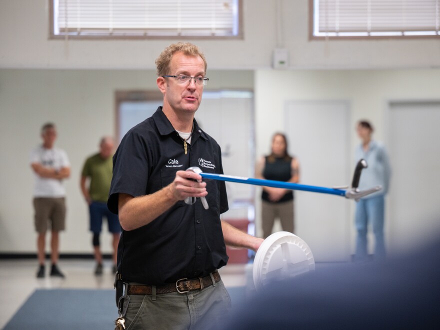 Cale Morris of the Phoenix Herpetological Society holds snake tongs as he leads a class on rattlesnakes at the Florence Ely Nelson Desert Park in Scottsdale, Arizona, U.S., May 14, 2024. Morris demonstrated ways to safely interact with a rattlesnake in order to relocate and release them without hurting them or getting bitten.