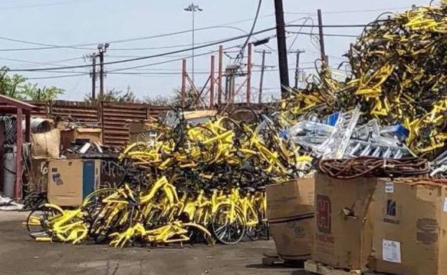 Ofo bikeshare bikes are piled up at a Dallas recycling center on Friday after the company decided to exit the market.