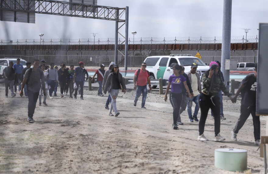  U.S. Border Patrol agents walked about 100 people 10 miles along the border highway to a station for processing on May 6. 