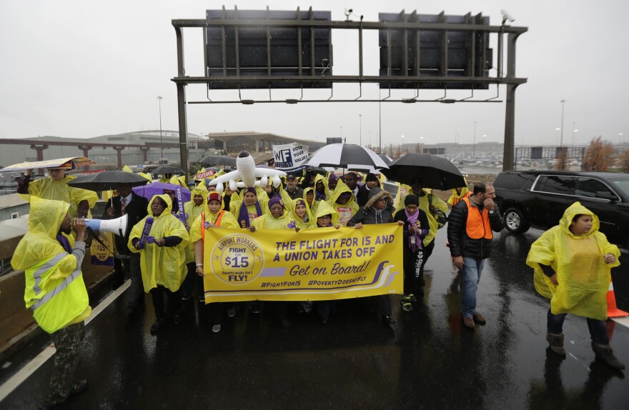 Service workers march at Newark Liberty International Airport in November 2016, asking for $15 minimum wage.