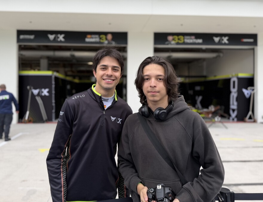 Spanish driver Pepe Martí, left, stopped to take photos with some students. Santiago Zamudino, right, made sure to snap one with the