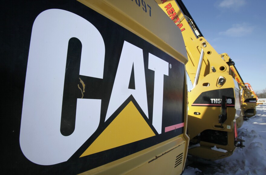 FILE - This Jan. 26, 2010 file photo shows Caterpillar equipment available at the Ziegler CAT dealer, in Altoona, Iowa. Caterpillar on Thursday, Sept. 24, 2015 said it is planning another round of job cuts that could exceed 10,000 people through 2018, as the construction and mining equipment maker adjusts to downturns in key markets that it serves. (AP Photo/Charlie Neibergall, File)