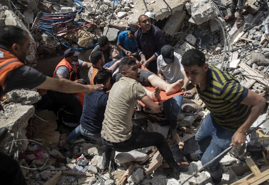 On May 16, Palestinians rescue a survivor from the rubble of a destroyed residential building following deadly Israeli airstrikes in Gaza City. The Gaza Strip's already feeble health system is being brought to its knees by the fourth war in just over a decade.