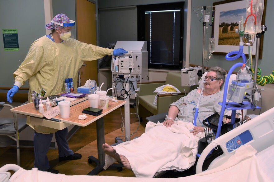In 2021, a nurse tends to 63-year-old Annette Cyphert. A COVID diagnosis made it difficult to do even the simplest of tasks, like talking to family via the phone – something she tried to do every day to combat the loneliness.