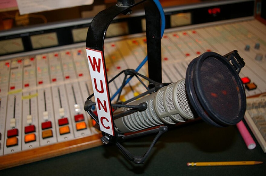 Picture of WUNC microphone and control room board