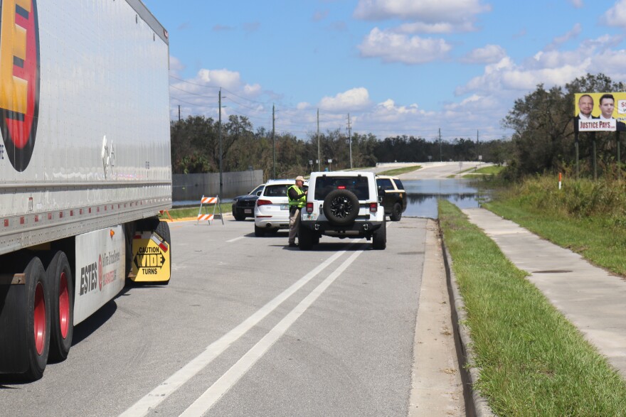 Florida Highway Patrol troopers reroute drivers to their destination at a closed flooded road in Arcadia, Florida. (Jake Reyes/WUFT News)