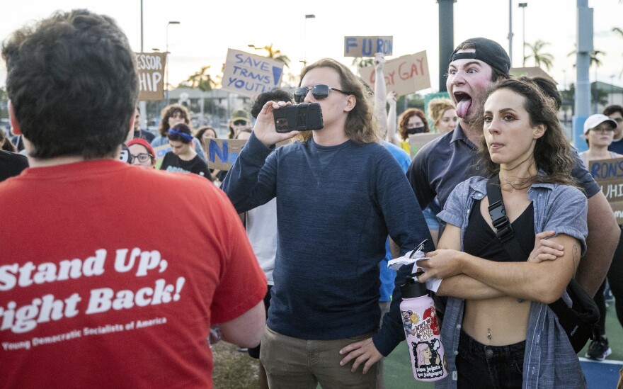 A supporter, right, of Florida Governor Ron DeSantis heckles a FGCU student on Sunday outside DeSantis' campaign rally at Alico Arena in Fort Myers. More than 30 FGCU students marched from the campus' Veterans Pavilion to Alico Arena in protest of DeSantis speaking at the rally. The protest was organized by the Young Democratic Socialists of America at FGCU, who oppose DeSantis' policies on education, LGBTQ and abortion.