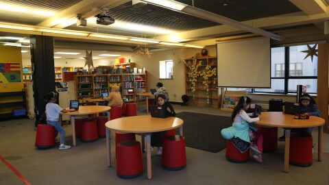Elementary students practice reading with Amira Learning in the library at Tenderloin Community Elementary School. 