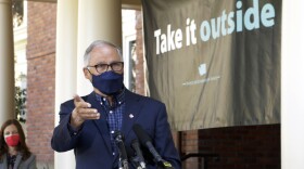 Washington Gov. Jay Inslee speaks to reporters outside the governor's mansion in Olympia on April 15, 2021. Inslee held the outdoor news conference to urge people to get vaccinated and to socialize and conduct business outside as much as possible.