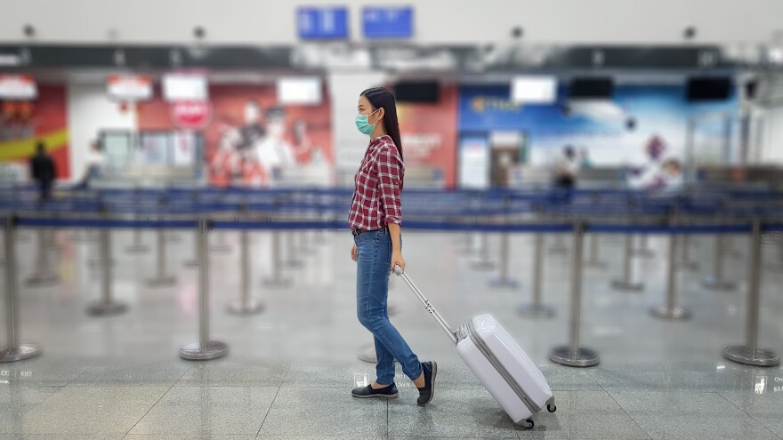 A person wearing a mask at an airport