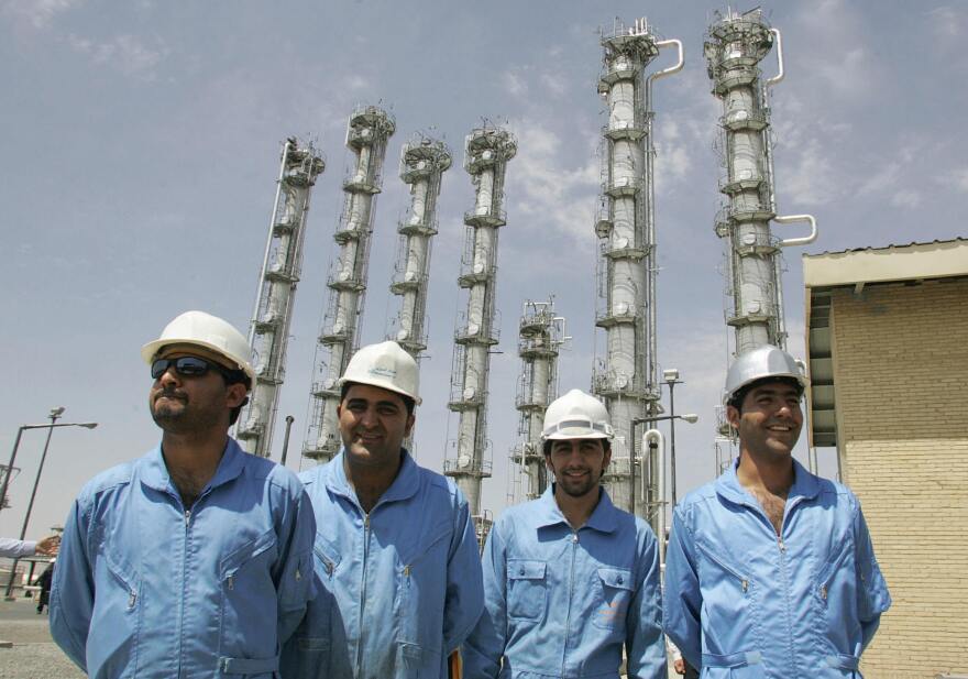 Iranian employees pose for a picture at the newly opened heavy water plant in Arak, in 2006. Iran is negotiating with six world powers on the fate of the plant and other issues concerning its nuclear program.