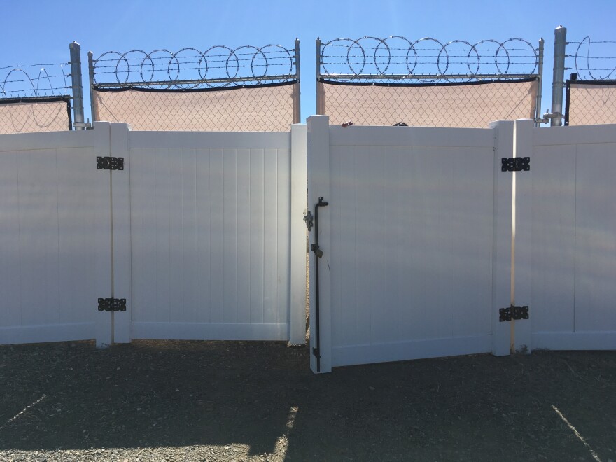 A double set of fences topped with barbed wire circles this outdoor decomposition site outside Grand Junction, Colo. The barrier thwarts prying eyes and protects the curious from an unpleasant surprise.