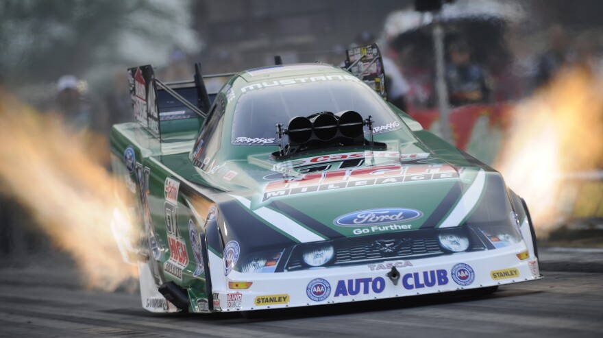 John Force launches from the starting line at the 2012 O'Reilly Auto Parts Route 66 National Hot Rod Association Nationals in Joliet, Ill.