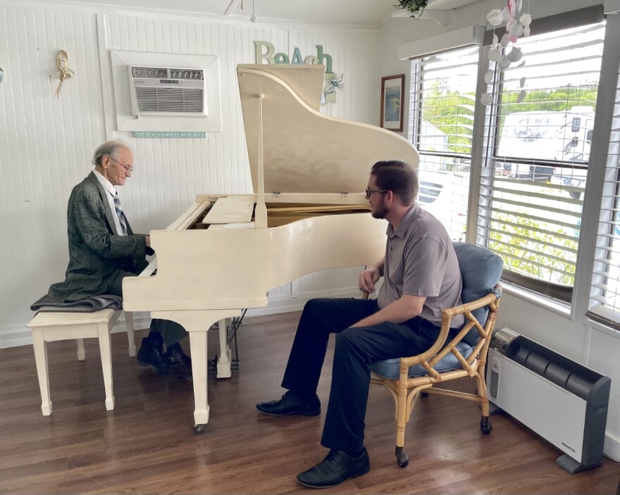 Justin Willis listens as Zbigniew Szymczak (Ziggy) plays piano in his new home