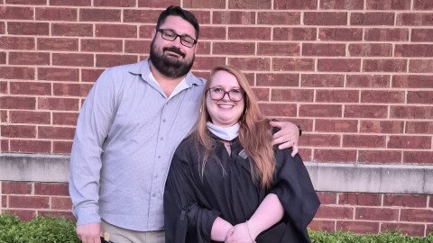 Grace Englehart and her husband Joshua Clarke pose after her graduation from Lindenwood University in St. Charles, Missouri, on May 7, 2026. Earning her Master of Fine Arts degree left Englehart with a hefty student loan bill.