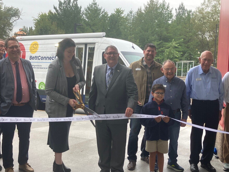 Bettendorf Public Library Director Jillian Aschliman cuts the ribbon (with Mayor Bob Gallagher) on the library's new outreach vehicle, Wednesday, Sept. 30, 2026.