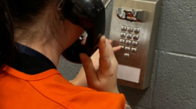 An Oklahoma County Detention Center detainee uses a jail phone.