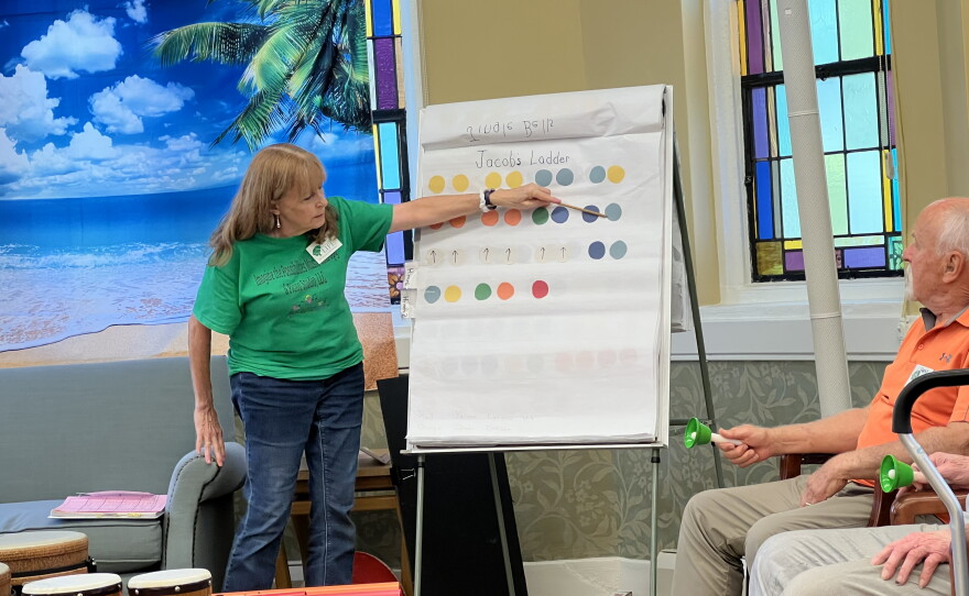 Each week, a music therapist guides memory cafe participants through a song on the handbells.