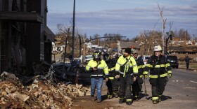 Firefighters survey tornado damages in downtown Mayfield, Kentucky.