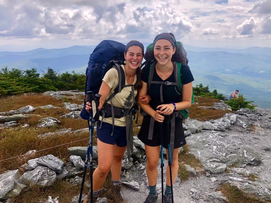 Two Long Trail thru hikers stand on the summit of Mt. Abe.