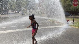 Trying to keep cool in Chicago: On Wednesday, 7-year-old Keshyra Pitts played in the spray from a fire hydrant.