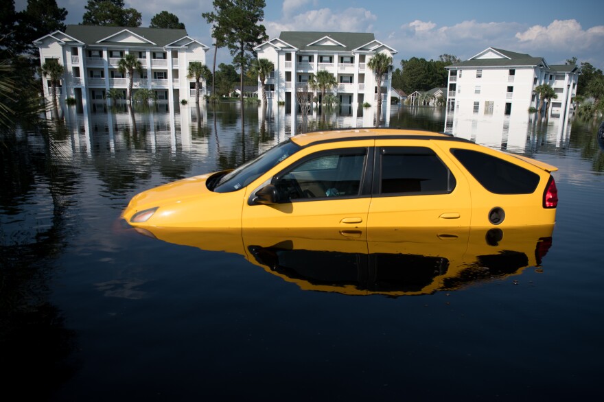 Climate change makes intense floods, wildfires, hurricanes and heat waves more common. Recovering from a disaster can be expensive. Here, a flooded car after Hurricane Florence hit South Carolina in 2018.