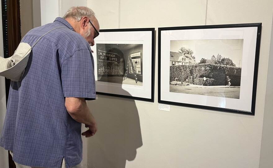 A Wistariahurst museum-goer at photographer Charles Abel's exhibit titled "Pictorially Speaking," an exhibit of new photographs of the city of Holyoke taken through the lens of a 100-year-old camera.