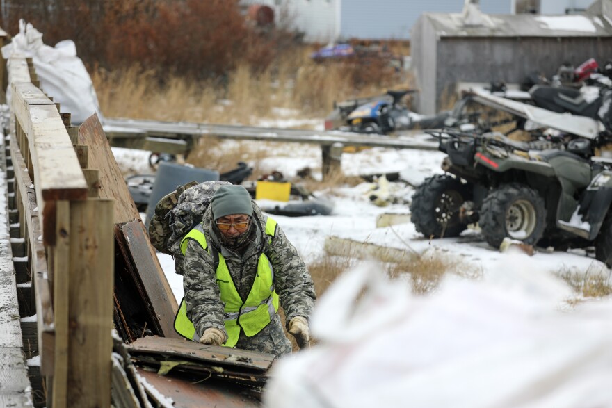 An Alaska Organized Militia member, assigned to Task Force Bethel, cleans up debris at Tuntutuliak, Alaska, during post-storm recovery efforts for Operation Halong Response, Oct. 25, 2025. AKOM members, including Alaska Air and Army National Guardsmen and members of the Alaska Naval Militia and Alaska State Defense Force, continue coordinated response operations in support of the State Emergency Operations Center following Typhoon Halong.