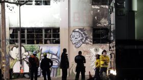 Emergency personnel stage in front of the site of a warehouse fire that started Friday night and killed dozens, Sunday, Dec. 4, 2016, in Oakland, Calif. (Marcio Jose Sanchez/AP)