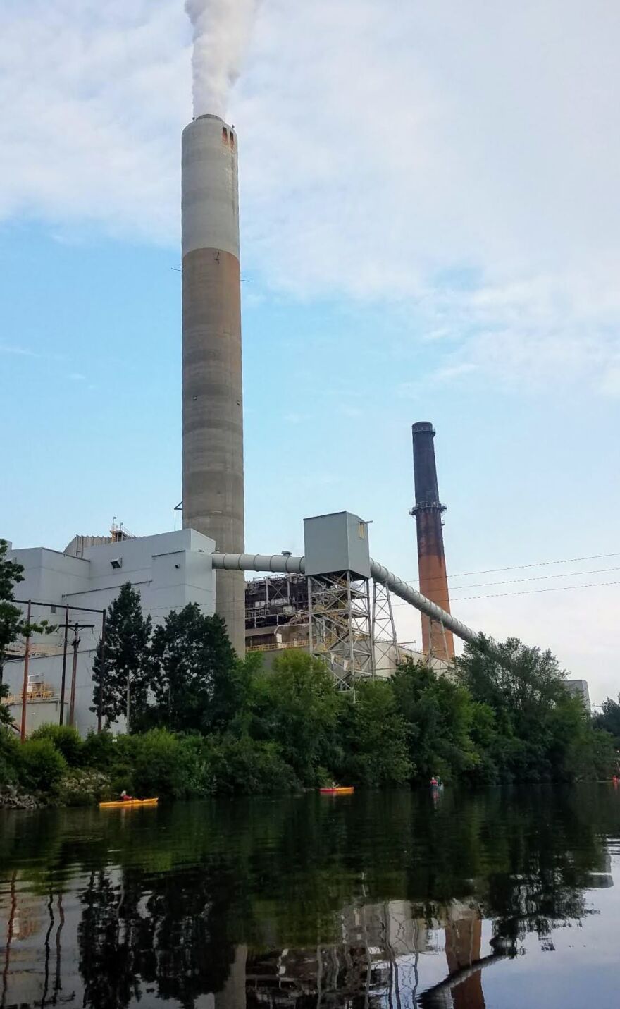 "Kayaktivists" hung a banner that read "CLOSED" high up on the back of the Bow coal plant Wednesday morning. They left a plant on the premises with a sign saying "Plant a better future."