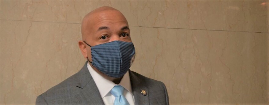 A headshot of Assembly Speaker Carl Heastie wearing a blue face mask