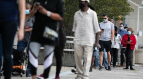 Voters line up outside of State Farm Arena, Georgia's largest early voting location, for the first day of early voting in the general election on October 12, 2020 in Atlanta, Georgia. (Jessica McGowan/Getty Images)