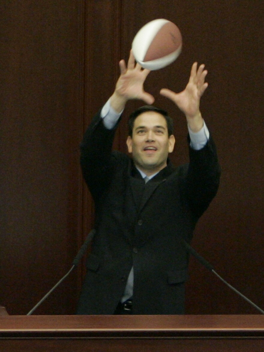 Rubio, who went to college on a football scholarship, catches a pass from University of Florida quarterback Chris Leak during Leak's visit to Florida's House of Representatives in 2007.