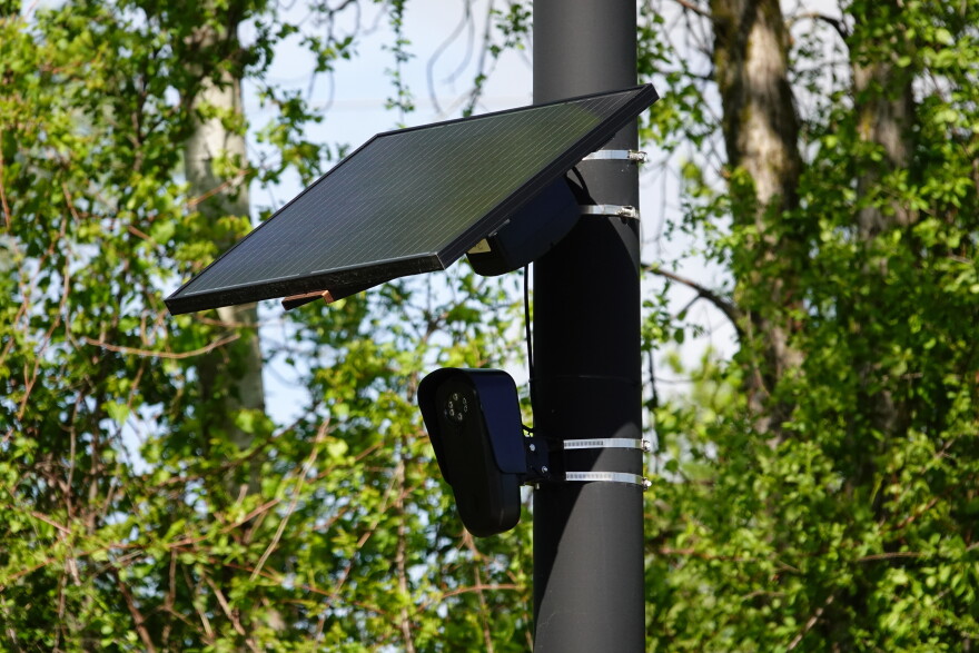 A Flock camera attached to a pole.