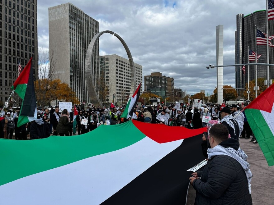 Protestors unfurl a large Palestinian flag at a protest in Detroit.