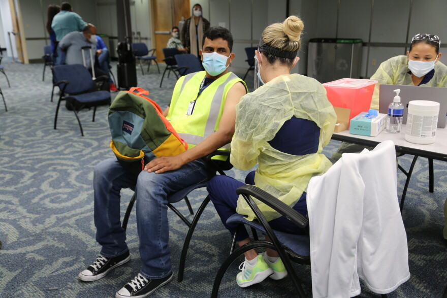 Luís Ochoa gets his first Pfizer vaccine dose on May 10, 2021 at Miami International Airport. Ochoa works as part of cabin crews that clean airplanes.
