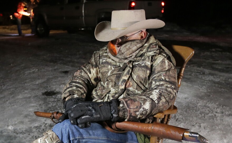 FILE - Arizona rancher LaVoy Finicum, holds a rifle as he guards the Malheur National Wildlife Refuge near Burns, Ore., on Jan. 5, 2016. Over the past decade, Oregon experienced the sixth-highest number of extremist incidents in the nation, despite being 27th in population, according to an Oregon Secretary of State report. Now, the state Legislature is considering a bill that, experts say, would create the nation's most comprehensive law against paramilitary activity.