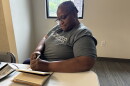 Audrey Carma, founder of WannaBuddy, writes in her journal before an interview.