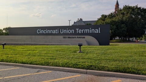 An outdoor marquee for Cincinnati's Union Terminal on a grassy strip.