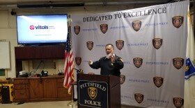 A man stands in front of a podium.