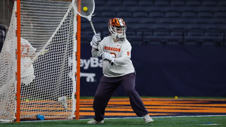 Syracuse goalie Daniella Guyette (0, White) clears the ball in No. 14 SU’s loss 13-9 loss to No. 1 North Carolina on Friday, February 13.