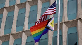 An American flag and LGBTQ+ flag