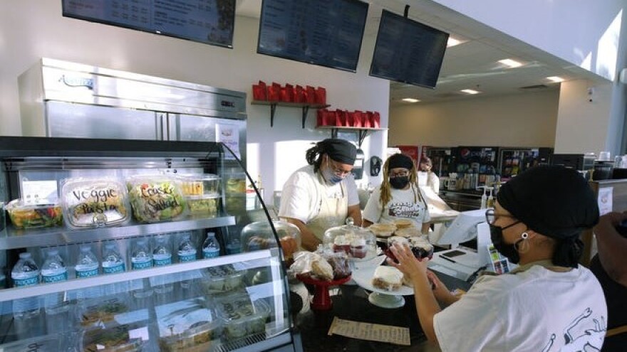 Assistant Manager Don Ashton, left, and cashier Dianthe Ashton work behind the counter at the new Crazy Beans Coffee.