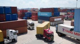 Trucks run by containers at an Inland Container Depot (ICD) terminal in Uiwang, South Korea, Friday, July 24, 2026. (Ahn Young-joon/AP)
