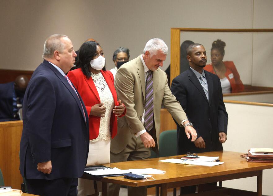 Rochester Mayor Lovely Warren and her estranged husband Timothy Granison stand at a court table with their attorneys