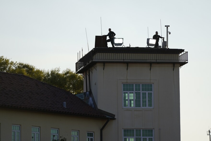 Security stands guard before Marine One with President Joe Biden on board arrives at Maxwell Air Force Base, Sunday, March 5, 2023, in Montgomery, Ala. Biden is returning to Washington after commemorating the 58th anniversary of "Bloody Sunday," a landmark event of the civil rights movement, in Selma, Ala. (AP Photo/Patrick Semansky)