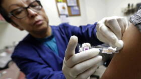 In this Thursday, Jan. 11, 2018 file photo, Ana Martinez, a medical assistant at the Sea Mar Community Health Center, gives a patient a flu shot in Seattle. This yearâ€™s U.S. flu season got off to an early start, and itâ€™s been driven by a nasty type of flu that tends to put more people in the hospital and cause more deaths than other common flu bugs.