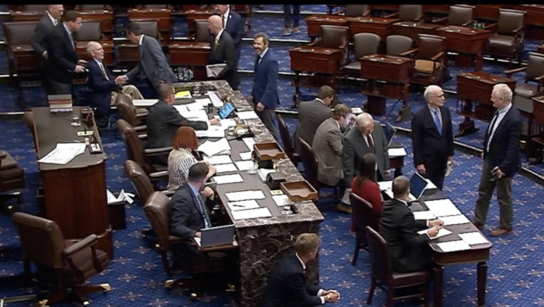 Sen. Mitch McConnell, wheeled out in a wheelchair, casts his first roll call vote since he was hospitalized after a fall in June.